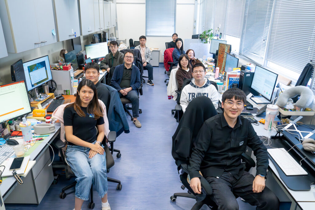 Professor Wu poses with his students in his lab