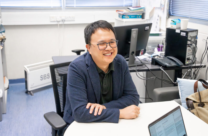 Professor Wu, an expert in AI forest monitoring, at his desk