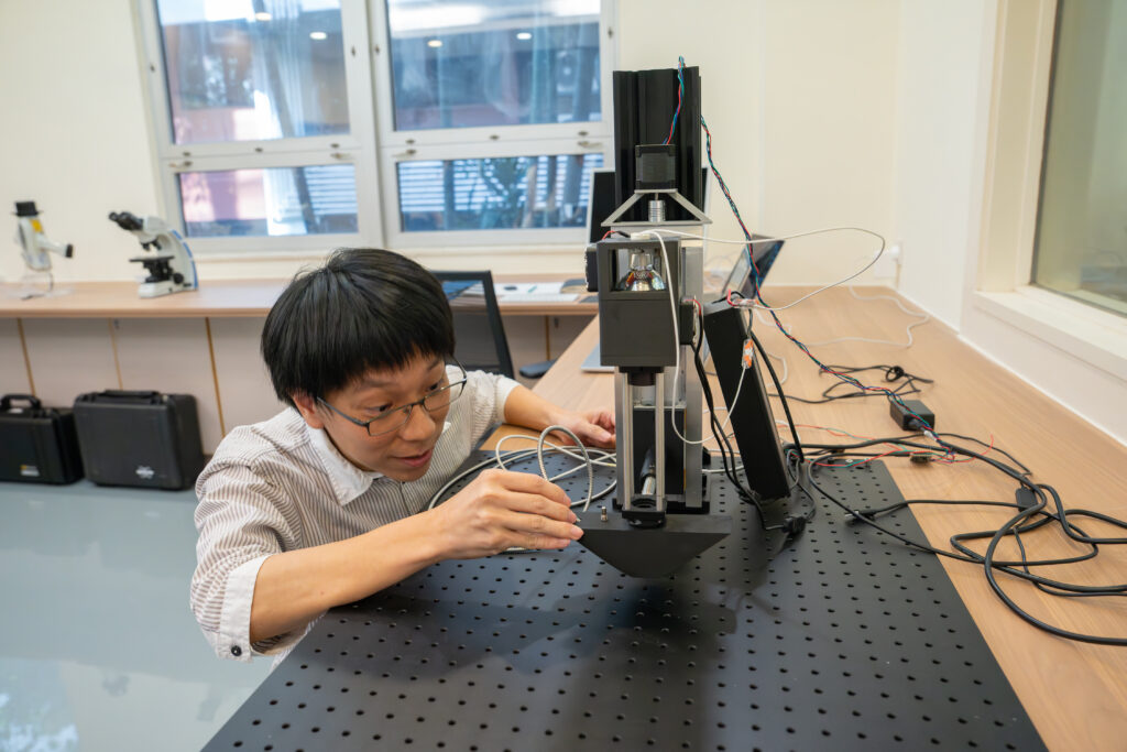 Dr Kenneth Ng inspects one of the lab's instruments